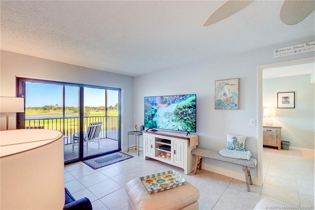 40 Northeast Plantation Road, Unit 309 Jensen Beach, FL 34957 - Photo 21 of 44 a living room with furniture and a flat screen tv