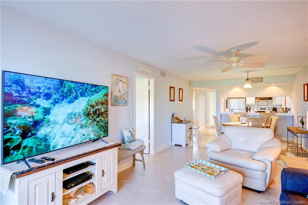40 Northeast Plantation Road, Unit 309 Jensen Beach, FL 34957 - Photo 23 of 44 a living room with furniture and a fireplace