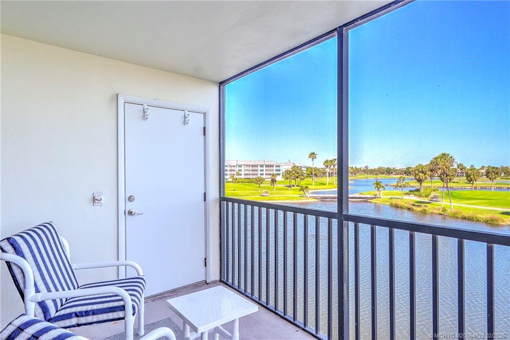 40 Northeast Plantation Road, Unit 309 Jensen Beach, FL 34957 - Photo 24 of 44 a view of a balcony with chair and floor to ceiling window