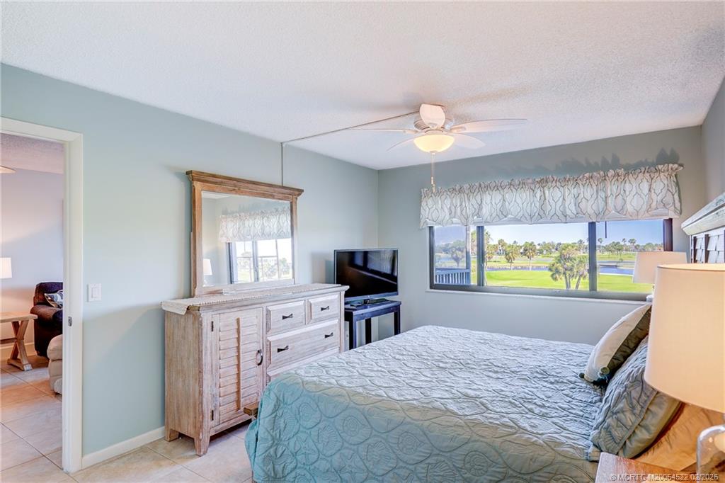 40 Northeast Plantation Road, Unit 309 Jensen Beach, FL 34957 - Photo 29 of 44 a bed room with a bed and a television