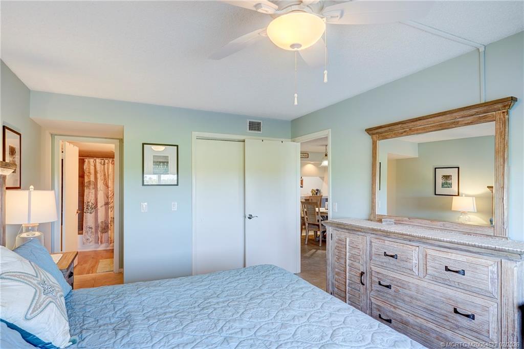 40 Northeast Plantation Road, Unit 309 Jensen Beach, FL 34957 - Photo 32 of 44 a bedroom with a bed and a dresser