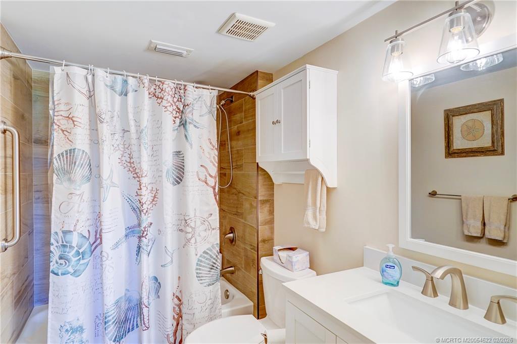 40 Northeast Plantation Road, Unit 309 Jensen Beach, FL 34957 - Photo 33 of 44 a bathroom with a sink and a mirror