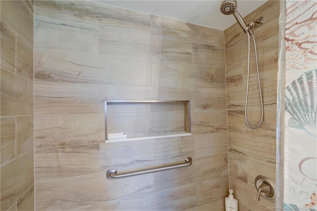40 Northeast Plantation Road, Unit 309 Jensen Beach, FL 34957 - Photo 35 of 44 a bathroom with a shower