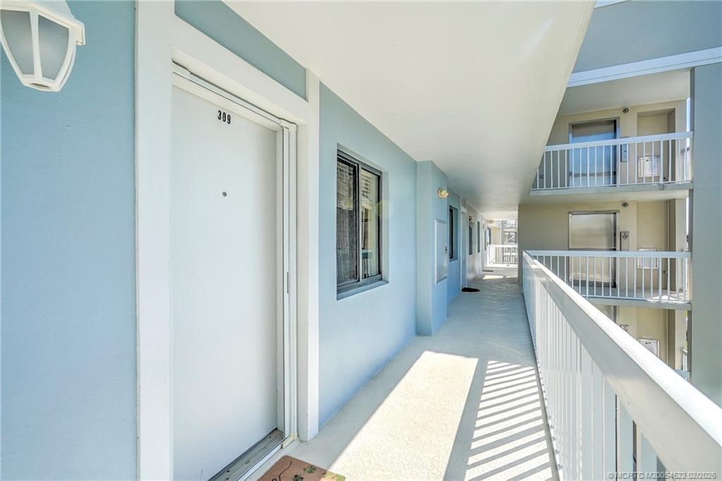 40 Northeast Plantation Road, Unit 309 Jensen Beach, FL 34957 - Photo 8 of 44 a view of a hallway with windows