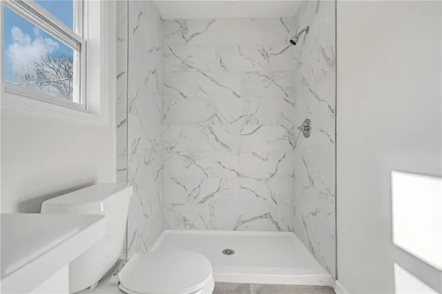 a bathroom with a bathtub and a toilet