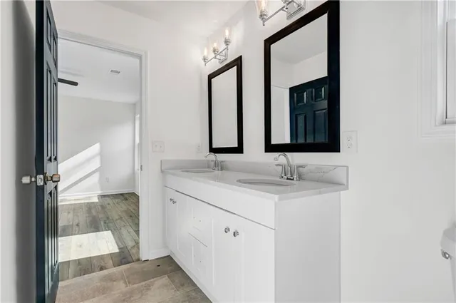 a bathroom with a granite countertop sink and a mirror
