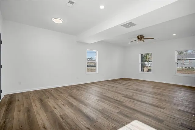 wooden floor in an empty room with a window