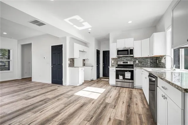 a kitchen with kitchen island a refrigerator sink and microwave
