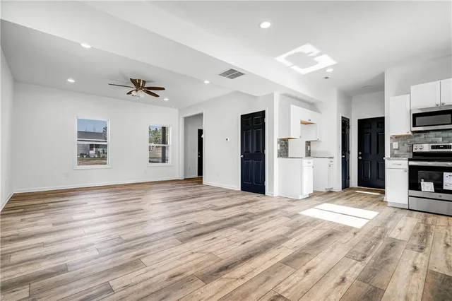a view of a kitchen with a stove cabinets and wooden floor