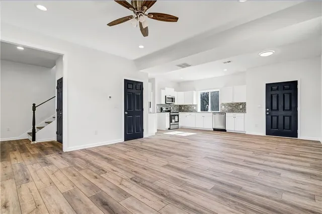 a view of a kitchen with a sink and a refrigerator