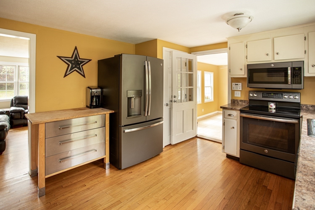 1332 Main Road Westport, MA 02790 - Photo 16 of 39 a kitchen with stainless steel appliances a stove a refrigerator and a microwave