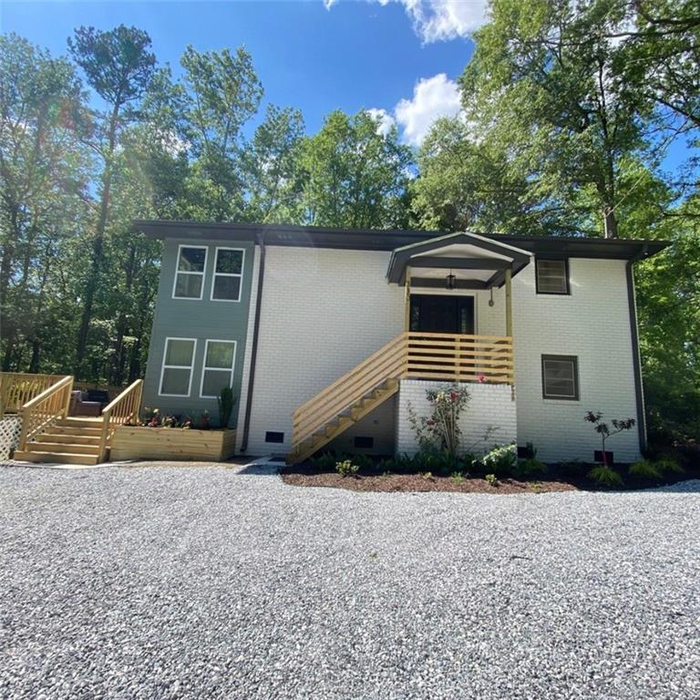 a view of a house with a yard and sitting area