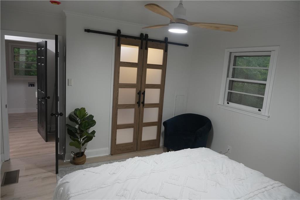 330 Ivy Trail Hartwell, GA 30643 - Photo 13 of 34 a bedroom with a bed and a potted plant