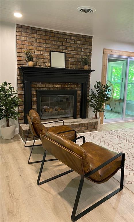 330 Ivy Trail Hartwell, GA 30643 - Photo 25 of 34 a living room with furniture a fireplace and potted plants with wooden floor