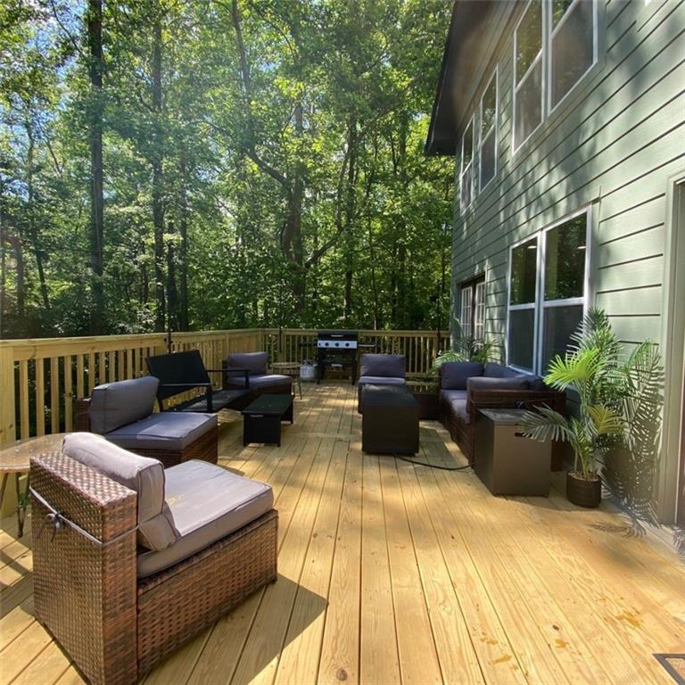 330 Ivy Trail Hartwell, GA 30643 - Photo 30 of 34 a view of a patio with couches chairs and wooden floor