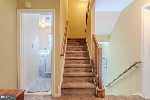 a view of a hallway with wooden floor and entryway