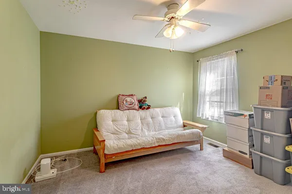 a bed sitting in a room next to a window