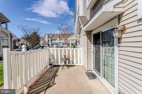 a view of a balcony with wooden floor and fence