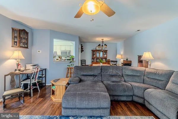 a living room with furniture and a dining table