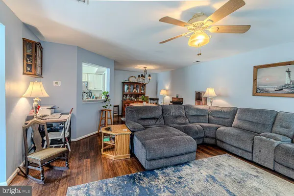 a living room with furniture a chandelier and a flat screen tv