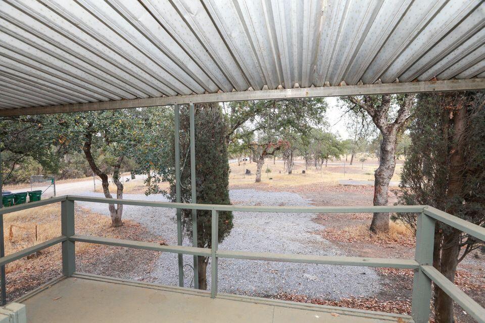 16947 Spring Creek Road Redding, CA 96003 - Photo 19 of 22 a backyard of a house with wooden floor and outdoor seating