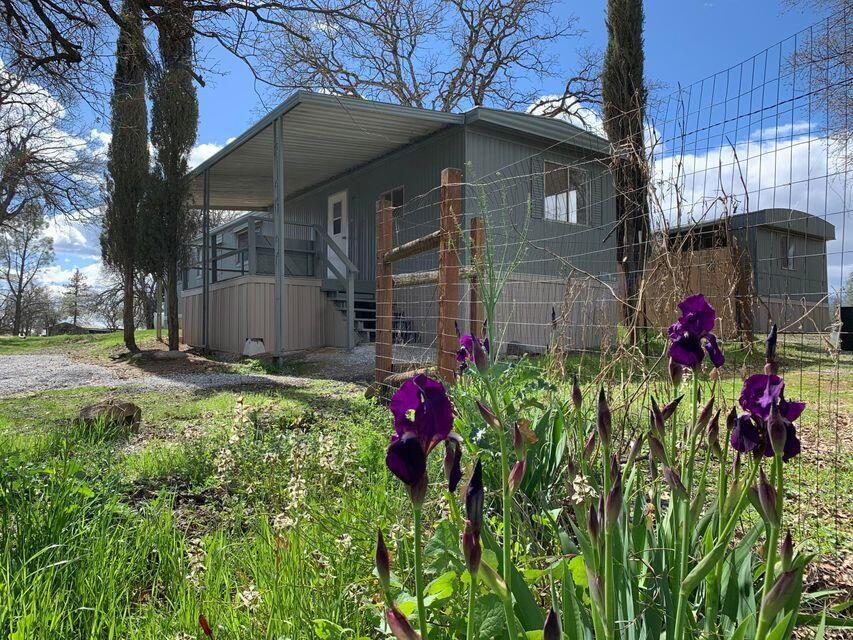16947 Spring Creek Road Redding, CA 96003 - Photo 2 of 22 a view of a house with a flower garden