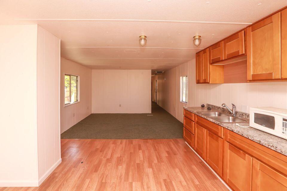 16947 Spring Creek Road Redding, CA 96003 - Photo 4 of 22 a view of a kitchen with a sink and wooden floor