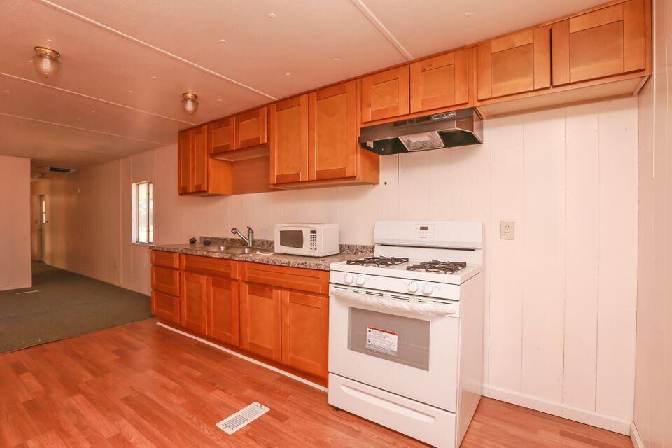 16947 Spring Creek Road Redding, CA 96003 - Photo 5 of 22 a kitchen with stainless steel appliances granite countertop a stove a sink and a refrigerator