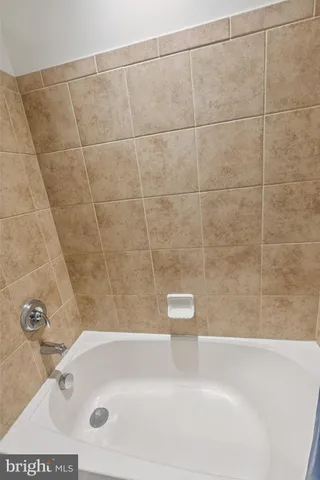 a bath tub sitting next to a white sink