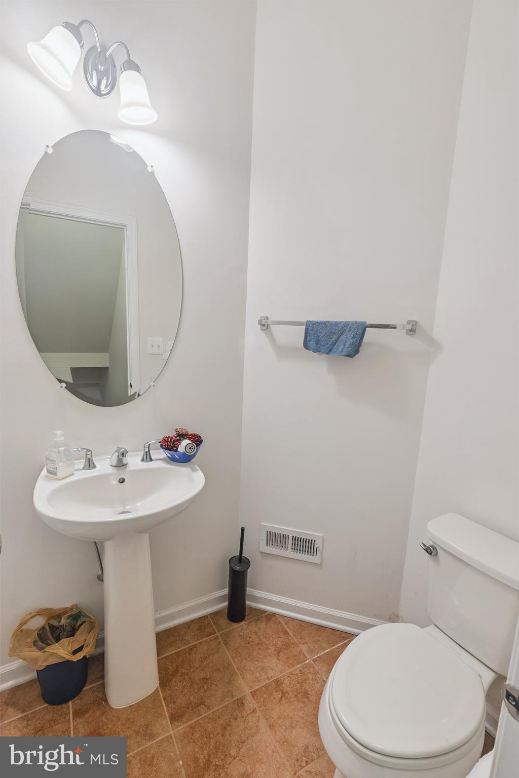 22551 Cambridgeport Square Ashburn, VA 20148 - Photo 12 of 49 a bathroom with a sink a toilet and a mirror