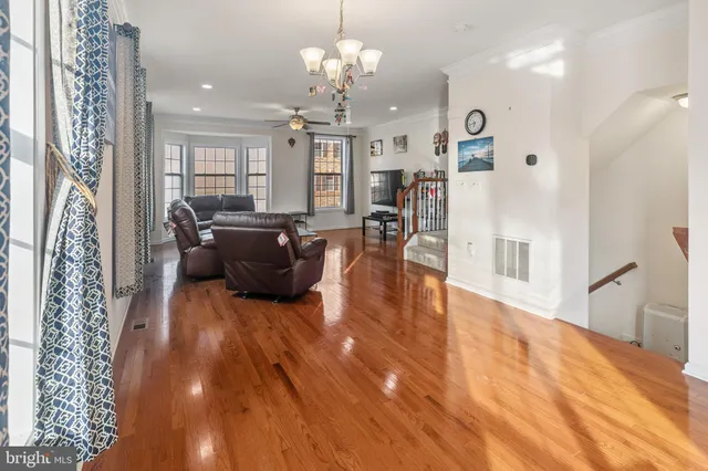 a living room with furniture dining table and a chandelier