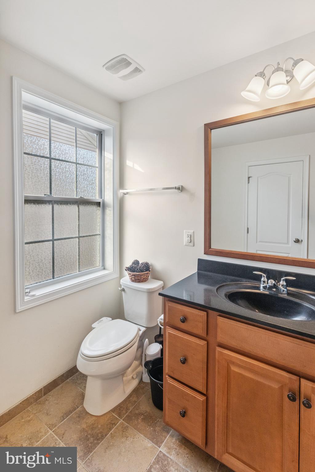 22551 Cambridgeport Square Ashburn, VA 20148 - Photo 22 of 49 a bathroom with a granite countertop toilet sink and mirror