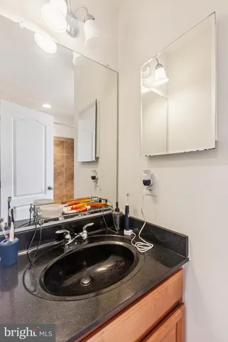 a kitchen with a sink and a stove with wooden floor