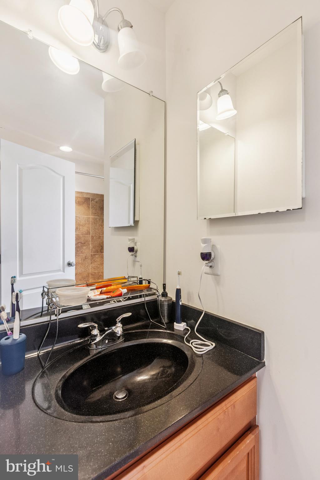 22551 Cambridgeport Square Ashburn, VA 20148 - Photo 27 of 49 a kitchen with a sink and a stove with wooden floor