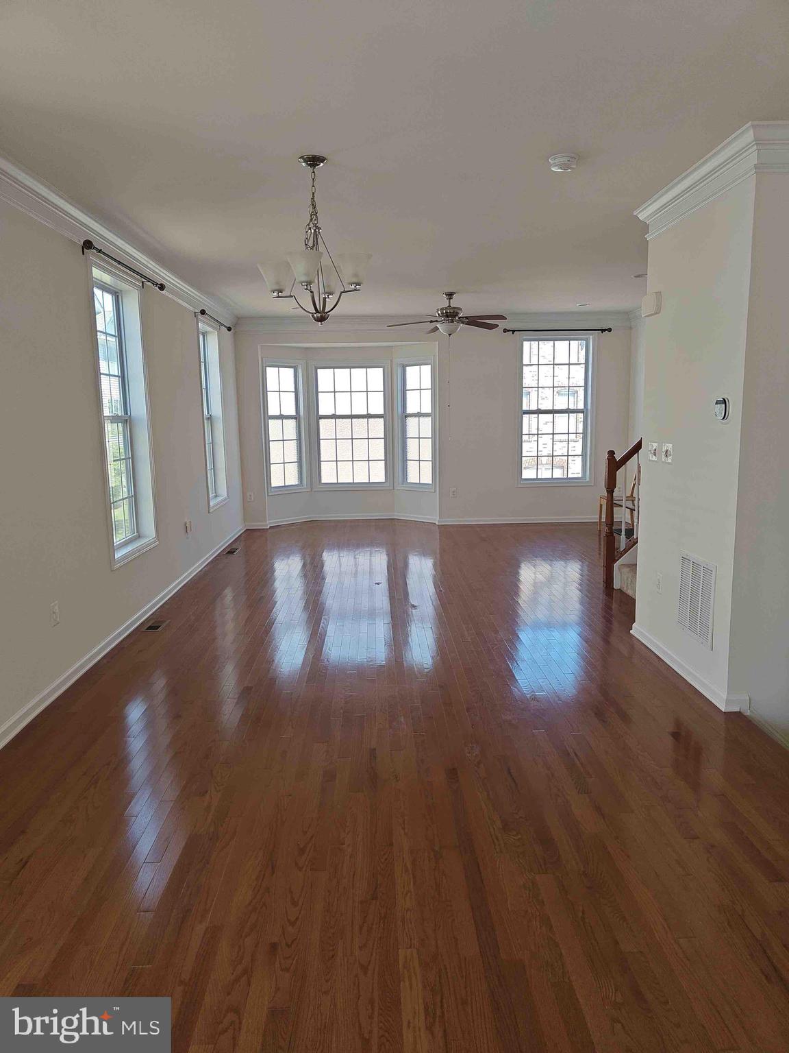 22551 Cambridgeport Square Ashburn, VA 20148 - Photo 35 of 49 a view of an empty room with wooden floor and a window