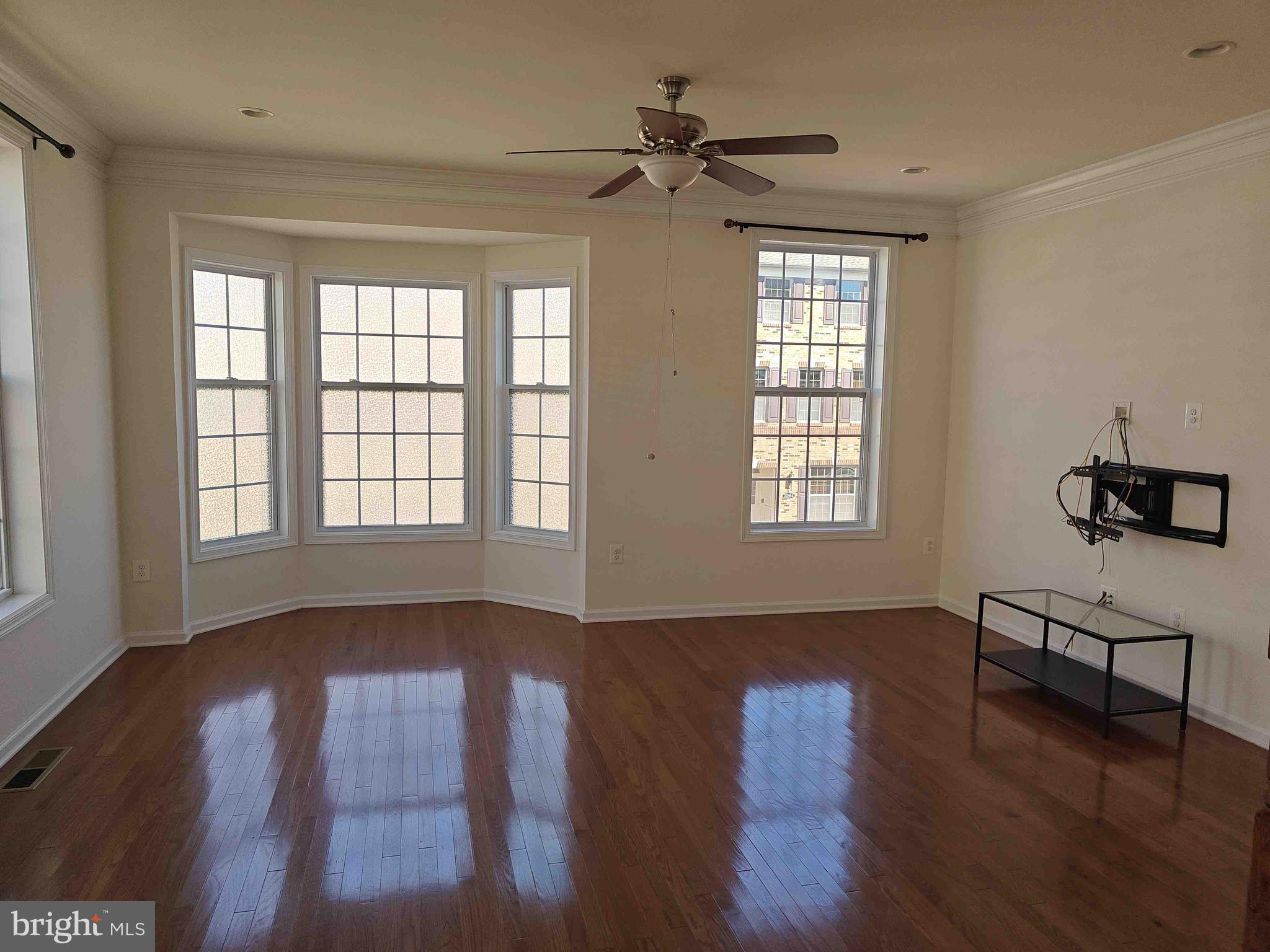 22551 Cambridgeport Square Ashburn, VA 20148 - Photo 39 of 49 a view of an empty room with wooden floor and a window
