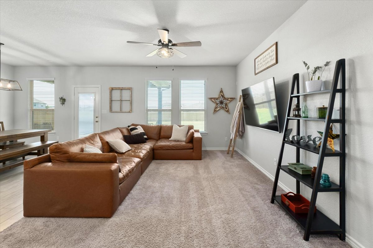 5408 Vanner Path Georgetown, TX 78626 - Photo 11 of 34 Spacious living area featuring light-toned carpeting and multiple windows