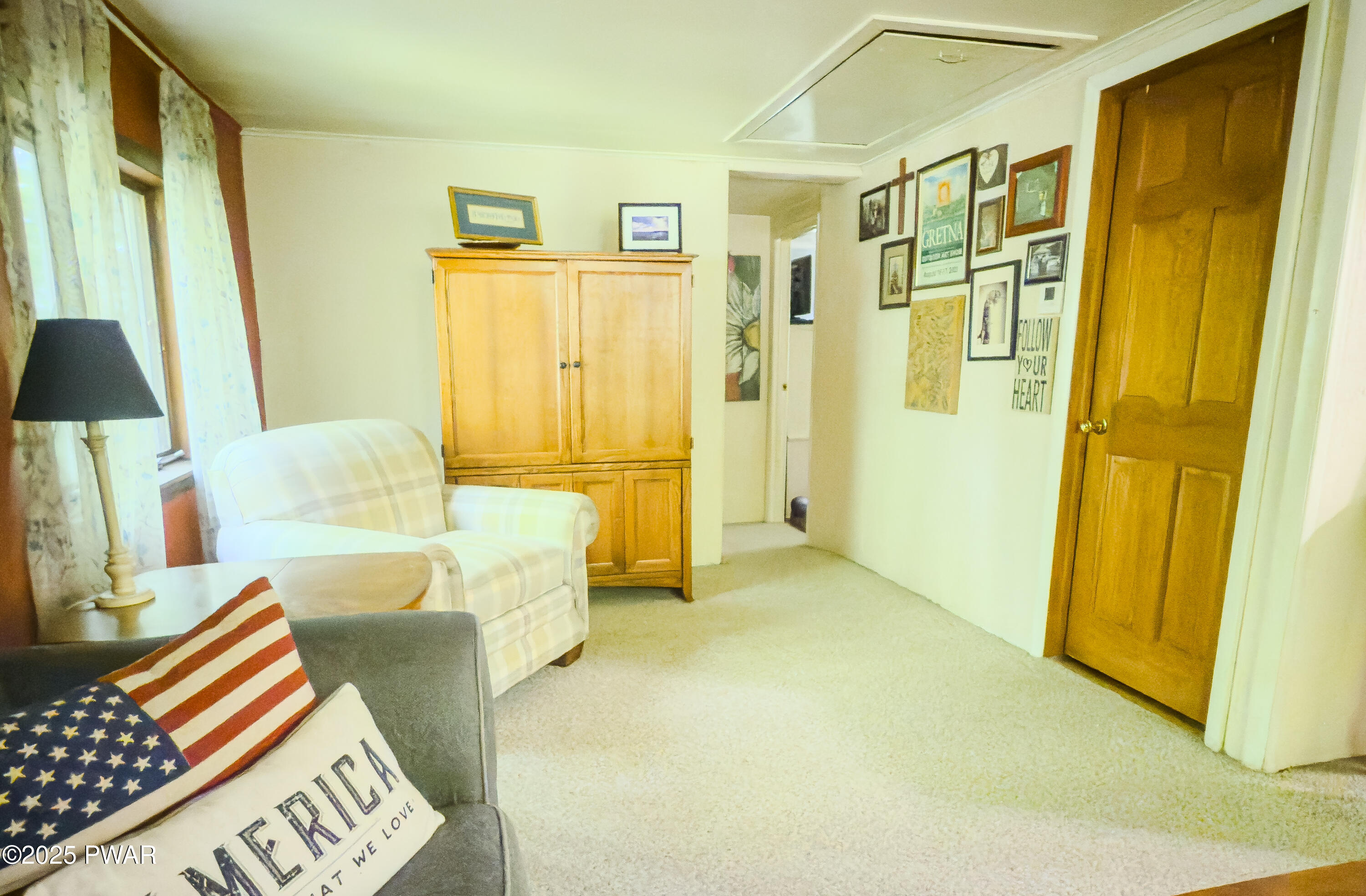 516 Lake Road Hawley, PA 18428 - Photo 18 of 28 a spacious bedroom with a bed and a couch
