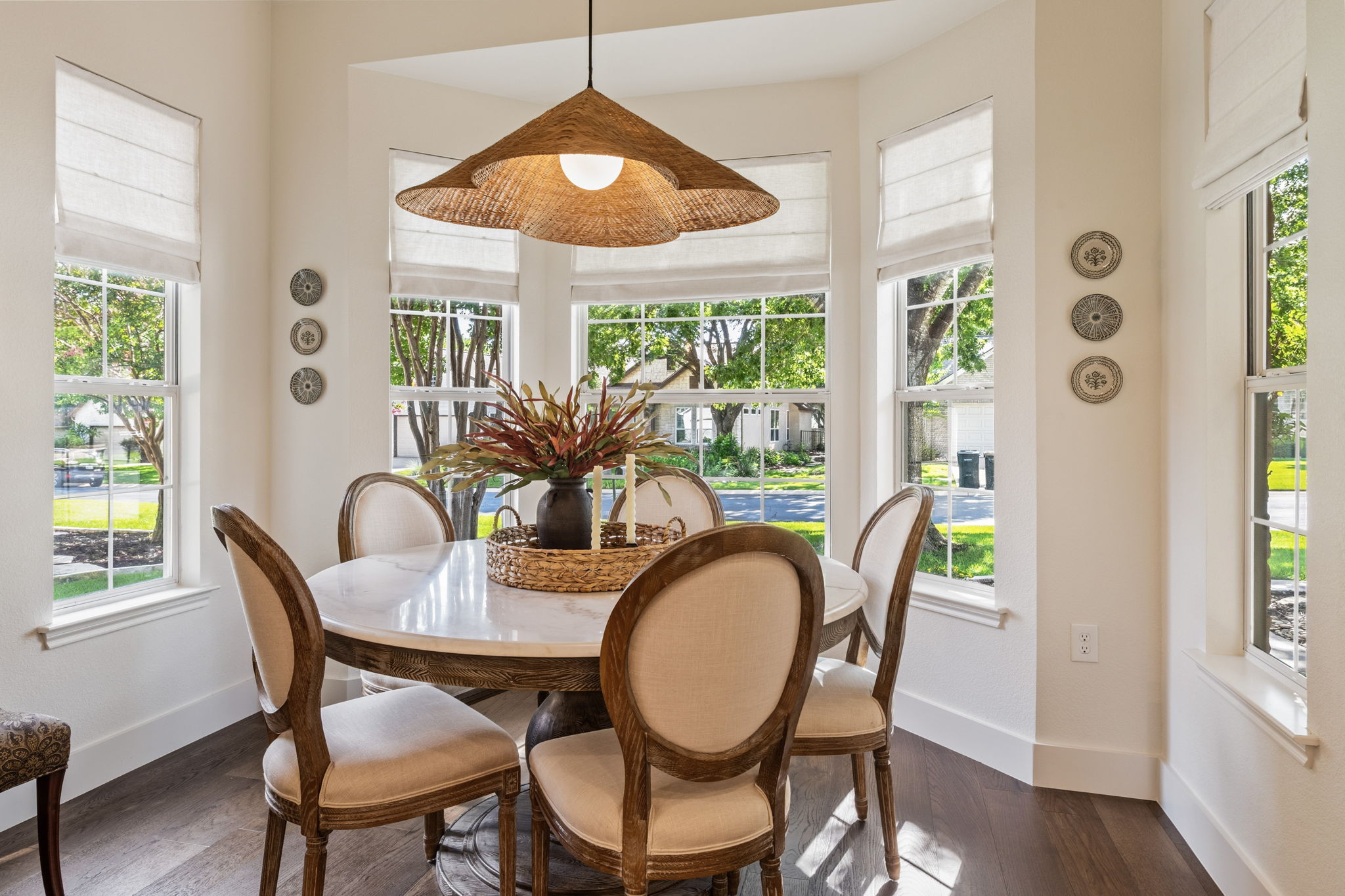 118 Cold Springs Drive Georgetown, TX 78633 - Photo 18 of 40 A well-lit breakfast area with rich hardwood flooring offers inviting views of the surrounding neighborhood through multiple windows.