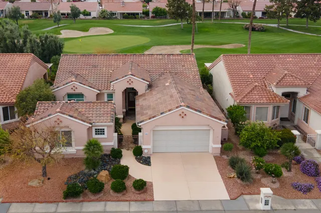 an aerial view of a house with a garden and trees
