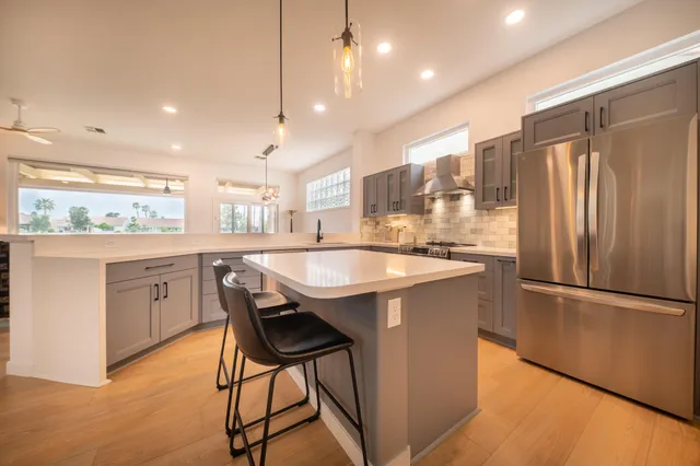 a kitchen with granite countertop a counter space a sink appliances and cabinets