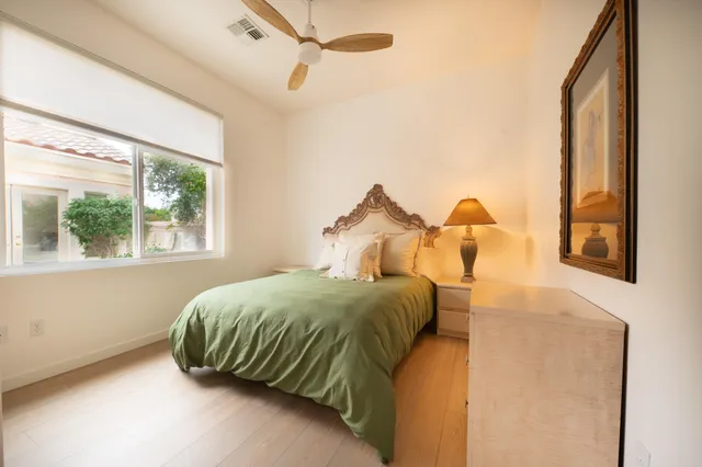 a bedroom with a bed and window