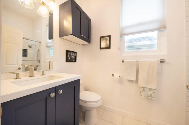 a bathroom with a sink a toilet and a mirror