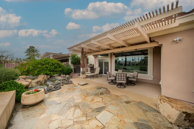 a view of a patio with table and chairs potted plants with wooden fence