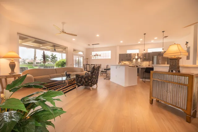 a living room with lots of furniture and a chandelier