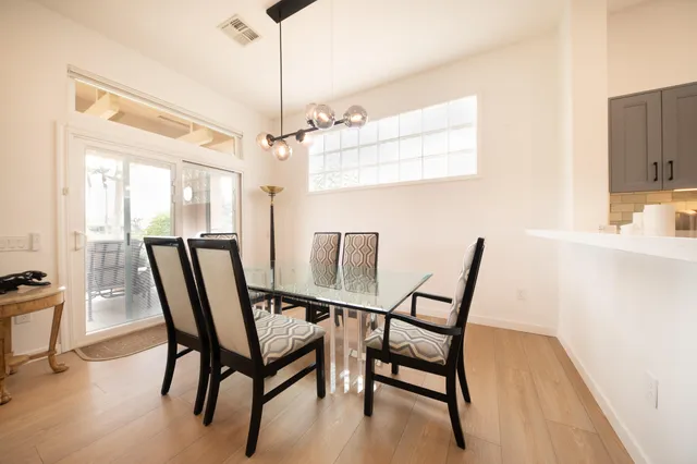 a view of a dining room with furniture and a window