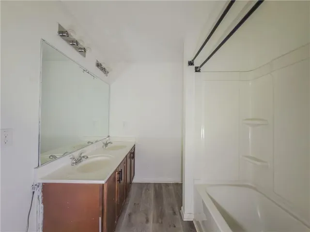a bathroom with a granite countertop sink a toilet and shower