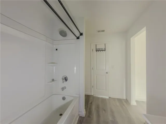 a bathroom with a bathtub and shower