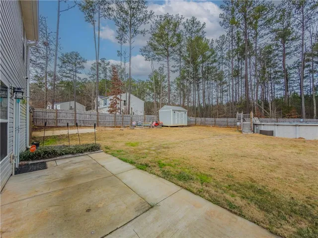 a swimming pool with outdoor seating and yard