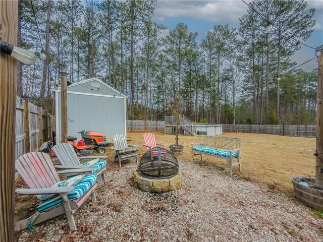 a backyard of a house with table and chairs
